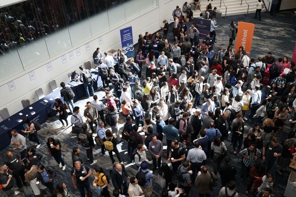 Thousands of people waiting in the entrance lobby to enter a convention/tradeshow