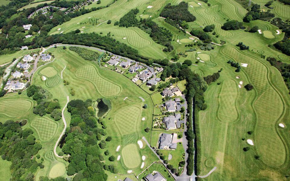 aerial view of a a golf course with houses