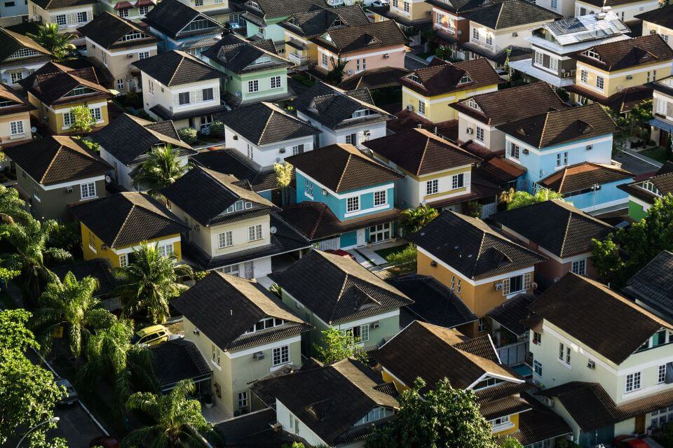 Aerial view of several rows of houses in a HOA governed neighborhood